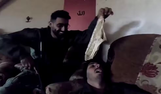 In one recording, soldiers hold up a pair of underpants near the face of a colleague pretending to be sleeping on a couch.