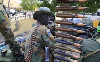 <p>Soldado do exército do Sudão do Sul fuma perto de metralhadora na cidade de Malakal, perto da capital Juba.País pode ter o maior crescimento do PIB no mundo em 2014</p>