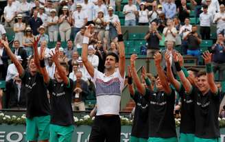 Djokovic saúda o público, junto com os gandulas da quadra, após vitória em Roland Garros