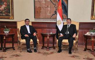 Presidente egípcio, Mohamed Mursi (D), encontra-se com presidente iraniano, Mahmoud Ahmadinejad, após chegada ao aeroporto internacional do Cairo, em foto de divulgação oficial. 05/02/2013