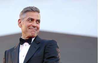 U.S. actor George Clooney smiles as he arrives on the red carpet for the premiere of "Gravity" at the 70th Venice Film Festival in Venice August 28, 2013. Clooney and Sandra Bullock star in Alfonso Cuaron movie "Gravity" which debuts at the festival.