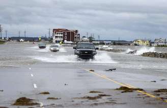 <p>Carros cruzam uma avenida alagada após a passagem do furacão Arthur em Nags Head, na Carolina do Norte, Estados Unidos, nessa sexta-feira</p>