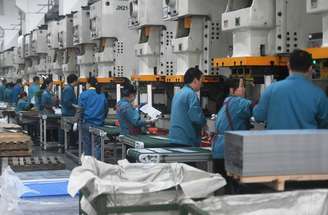 Trabalhadores de fábrica produzem chassis de servidores de alta-performance em Hangzhou, província de Zhejiang, na China. (16/04/2025)