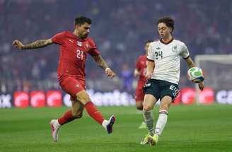 O lateral português Matheus Nunes (de vermelho) briga pela bola com o mexicano Jesús Gallardo.