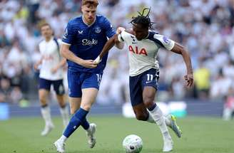 Jake O’Brien (de azul) tenta evitar que Mathys Tel leve o Tottenham ao ataque.