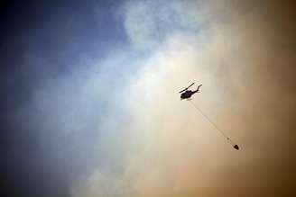 <p>Helicóptero joga água sobre incêndio florestal</p>