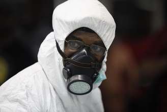 Agente de saúde, na Nigéria, se protege com vestimenta para cuidar de pacientes com ebola