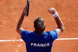(From L, visible faces) French team captain Arnaud Clement, Julien Benneteau, Michael Llodra, Jo-Wilfried Tsonga, Gael Monfils and Richard Gasquet (front) react after their victory over Czech Republic in the semi-final of the Davis Cup at the Roland Garros stadium in Paris September 14, 2014.
