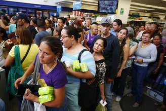 <p>Venezuelanos aguardam na fila do caixa dentro da farmácia Farmatodo em Caracas, em 3 de fevereiro. População não encontra medicamentos e produtos básicos nos supermercados</p>