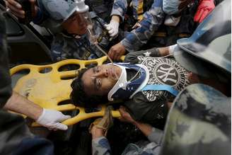 Pemba Lama, de 15 anos, é levado a uma ambulância após ser resgatado de escombros cinco dias depois do terremoto que atingiu Katmandu