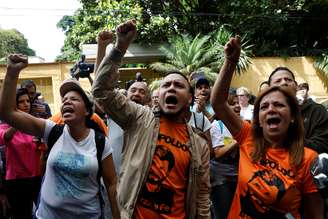 Manifestantes gritam palavras de ordem na entrada da casa do líder da oposição venezuelana Leopoldo López, que foi colocado em prisão domiciliar depois de mais de três anos de prisão