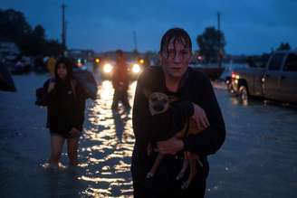 Mulher segura cachorro após deixar casa devido a enchentes em Houston
 28/8/2017    REUTERS/Adrees Latif