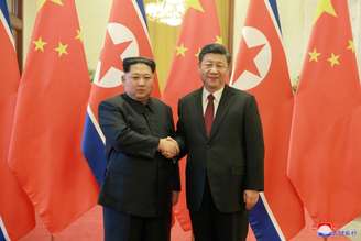 Líder norte-coreano, Kim Jong Un, cumprimenta presidente da China, Xi Jinping, em Pequim 28/03/2018 KCNA/via Reuters 