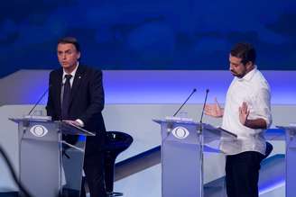 Jair Bolsonaro e Guilherme Boulos durante o debate da Band desta quinta-feira (9)