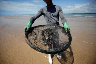 Homem atua na limpeza de derramamento de óleo na praia de Coruripe, Alagoas 
14/10/2019
REUTERS/Adriano Machado