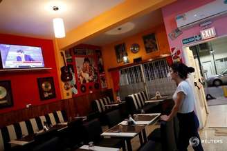 Garçonete assiste TV em restaurante vazio em Buenos Aires
18/03/2019
REUTERS/Agustin Marcarian