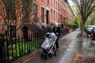 Mulher passeia com seu bebê usando máscara de proteção em Nova York
26/04/2020 REUTERS/Jeenah Moon