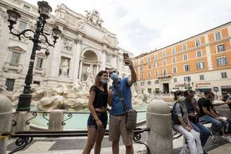 Amigos tiram foto em frente à Fontana di Trevi, em Roma, após reabertura