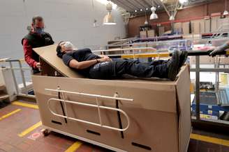 Rodolfo Gomez, a manager of the company "ABC Display" demonstrates how a hospital bed that the company manufactures is transformed into a cardboard coffin, amid the coronavirus disease (COVID-19) outbreak in Bogota, Colombia May 21, 2020. Picture taken May 21, 2020. REUTERS/Luisa Gonzalezz