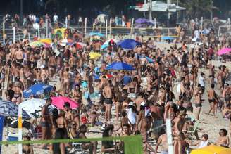 Banhistas lotam a Praia do Leblon, na zona sul da cidade do Rio de Janeiro, neste domingo. O decreto municipal liberou os ambulantes e o banho de mar-mas não a permanência na areia.