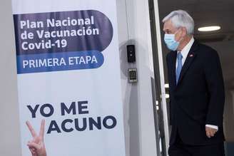 Sebastián Piñera com banner de campanha de vacinação contra Covid