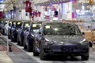 FILE PHOTO: Tesla China-made Model 3 vehicles are seen during a delivery event at its factory in Shanghai, China 
07/01/2020
REUTERS/Aly Song
