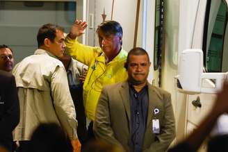 O ex-presidente Jair Bolsonaro (PL) acena a apoiadores ao chegar ao Hospital DF Star em Brasília.
