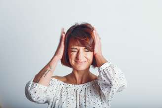 Girl in photo studio.A woman with a short haircut. Emotional girl