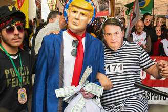 Manifestantes protestam contra falas de Trump na rua 25 de março, em São Paulo