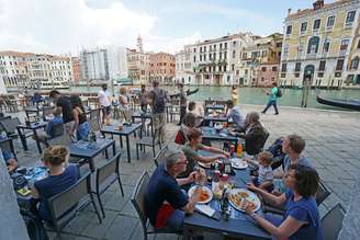 Turistas em bar em Veneza, joia turística da Itália