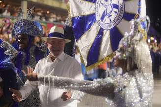 Lula desce para cumprimentar o casal de mestre-sala e porta-bandeira da Acadêmicos de Niterói, escola que homenageia o presidente