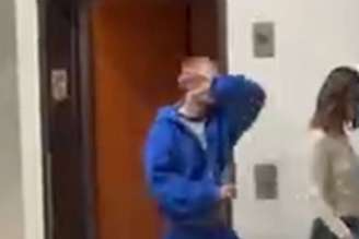 Justin Bieber colocando a mão sobre seu rosto