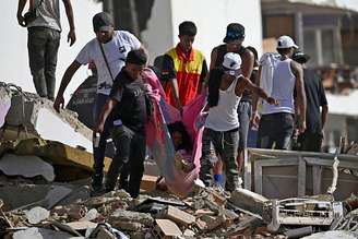 Moradores procuram sobreviventes entre os escombros em La Guaira