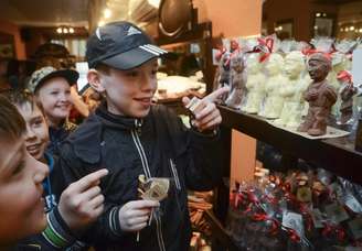 <p>Crianças observam os chocolates feitos em homenagem a Vladimir Putin.</p>