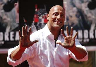Actor Dwayne "The Rock" Johnson poses after putting his hands in cement during his hand and footprints ceremony in the forecourt of the TCL Chinese Theatre in celebration of his new movie "San Andreas," in Hollywood, California May 19, 2015.