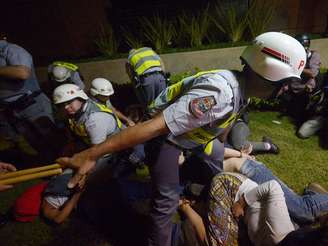 <p>Policiais detêm manifestantes que invadiram uma loja em São Paulo: eles foram liberados na madrugada</p>