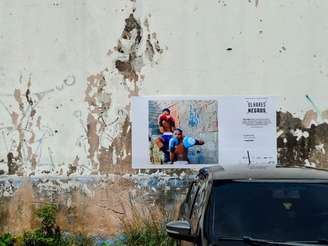 A paisagem do complexo de favelas da Maré é alterada com minidoors das fotografias que compõem a exposição de 20 jovens.