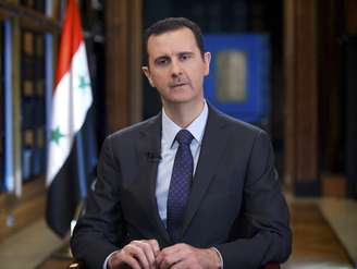 O presidente sírio Bashar al-Assad fala durante entrevista à emissora de TV venezuelana Tele SUR, em Damasco, em setembro de 2013