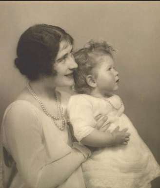 Mãe de Elizabethm a duquesa de York, com a princesa em 30 de junho 1927. A fotografia foi tirada três dias depois do duque e da duquesa de York voltarem de um período de seis meses na Austrália e na Nova Zelândia.