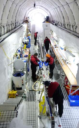 Pesquisadores trabalham em amostras de gelo recolhidas na ilha Roosevelt, na Antártida. A equipe cavou uma espécie de vala na neve a partir da qual perfurou o gelo